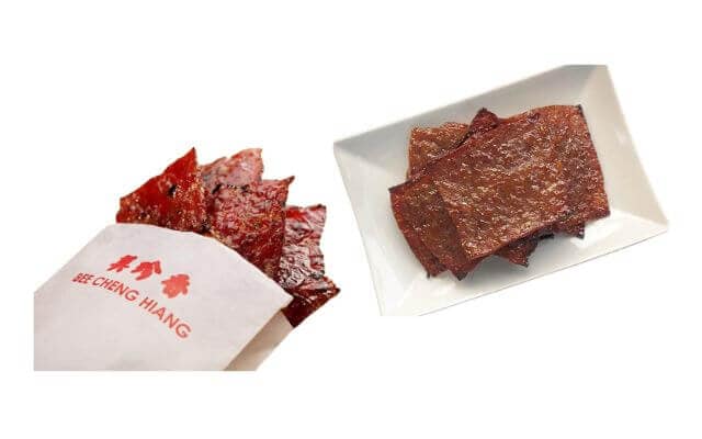 Slices of Singaporean barbecued pork jerky, known as Bak Kwa. On the left, several pieces of the jerky are shown peeking out of a white paper bag labeled "Bee Cheng Hiang," a well-known Bak Kwa brand. On the right, a neatly arranged stack of Bak Kwa slices is displayed on a rectangular white plate.