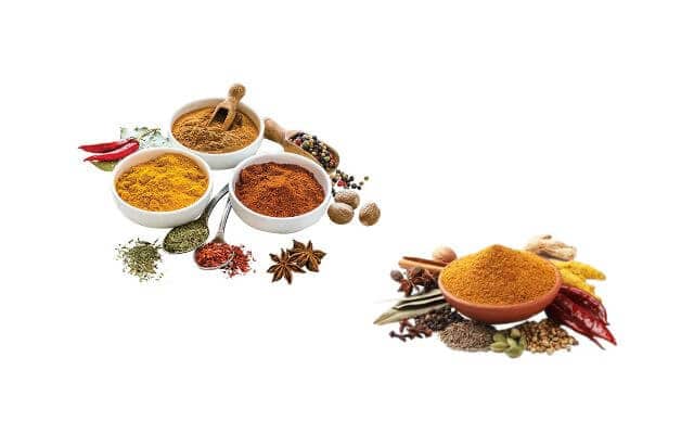 An assortment of colorful cooking spices, commonly used in Singaporean cuisine. On the left, several small white bowls contain various ground spices such as turmeric, chili powder, and curry powder, accompanied by ingredients like star anise, dried chilies, and peppercorns. On the right, a bowl of golden curry powder is surrounded by whole spices including cinnamon sticks, cardamom pods, mustard seeds, and red chilies.