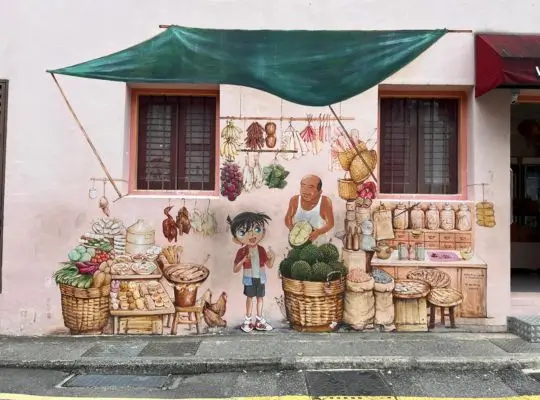 A charming street mural in Singapore's Chinatown featuring an animated-style character resembling Detective Conan standing next to an elderly vendor at a traditional market stall.