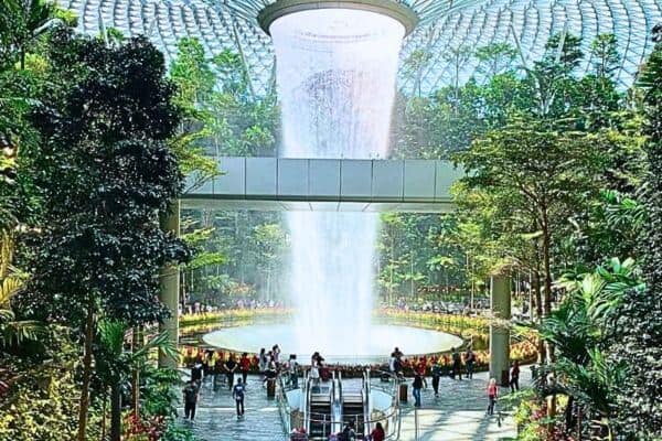 The HSBC Rain Vortex at Jewel Changi Airport in Singapore is the world's tallest indoor waterfall, pouring through a circular opening in the glass-domed roof. Surrounded by lush greenery, it creates a tropical forest vibe within the shopping and entertainment complex.